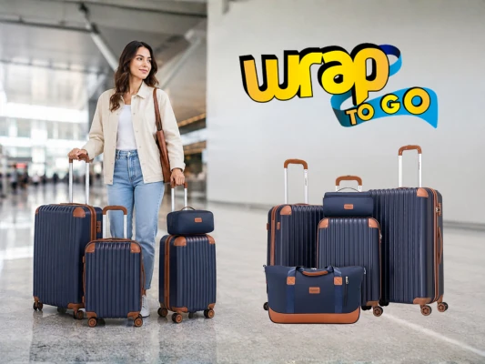 Persona transportando un juego de maletas con maleta de ruedas en un aeropuerto moderno durante un viaje.